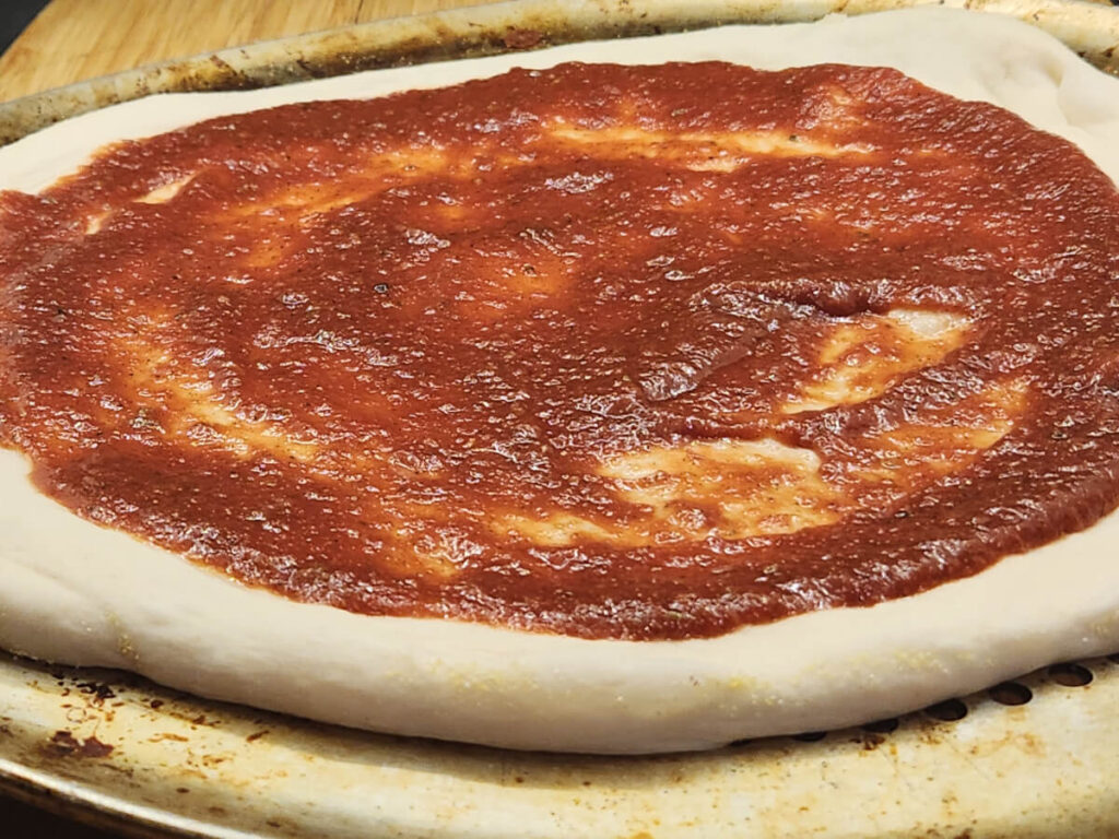 JAHZKITCHEN Overnight Hand Tossed Pizza Dough sauced with Pizza Thyme Sauce.